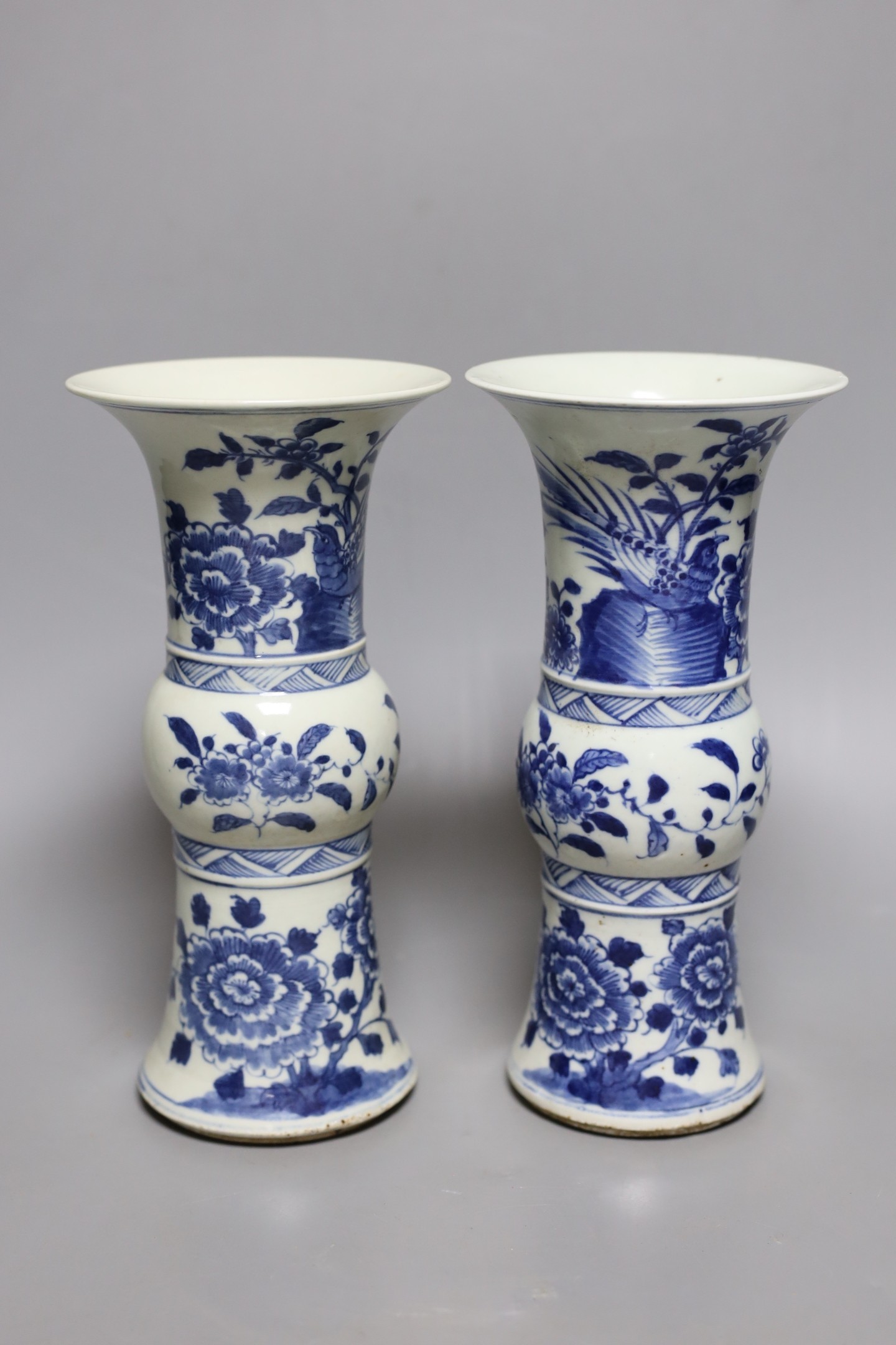 A pair of 19th century Chinese blue and white beaker vases, 23.5cm